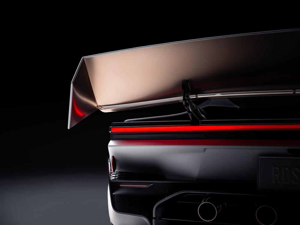 Rear of the Tesla Roadster with its large wing raised above the red light bar