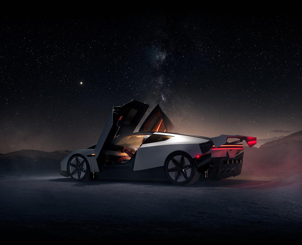 White Tesla Roadster with its doors raised, seen from the rear three-quarter under a starry sky