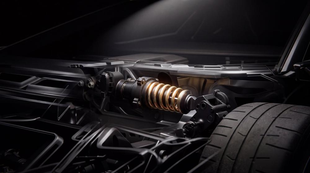 Tesla Roadster rear suspension and drive area with a gold damper and wide tyre