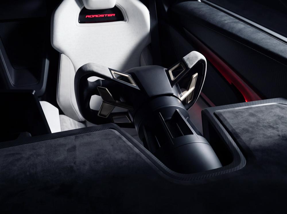 The yoke and sport seat in the Tesla Roadster's white interior