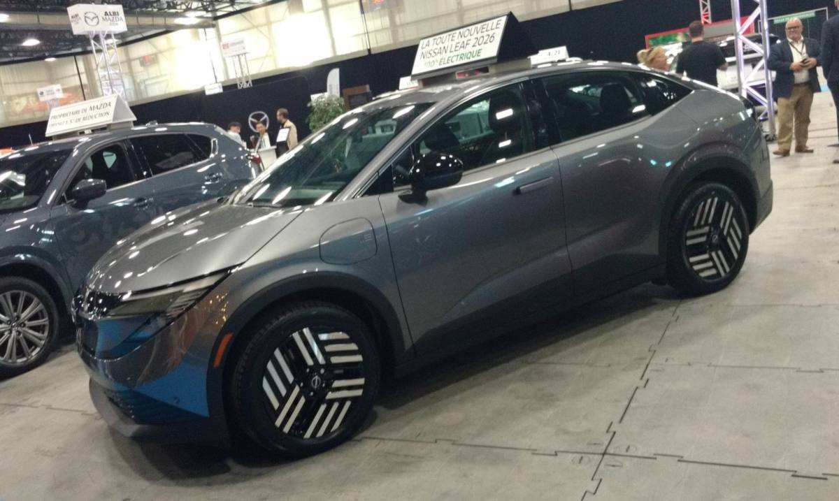 Grey 2026 Nissan Leaf on display at an auto show in Québec, the technical twin of the Mitsubishi Eclipse Sportback EV
