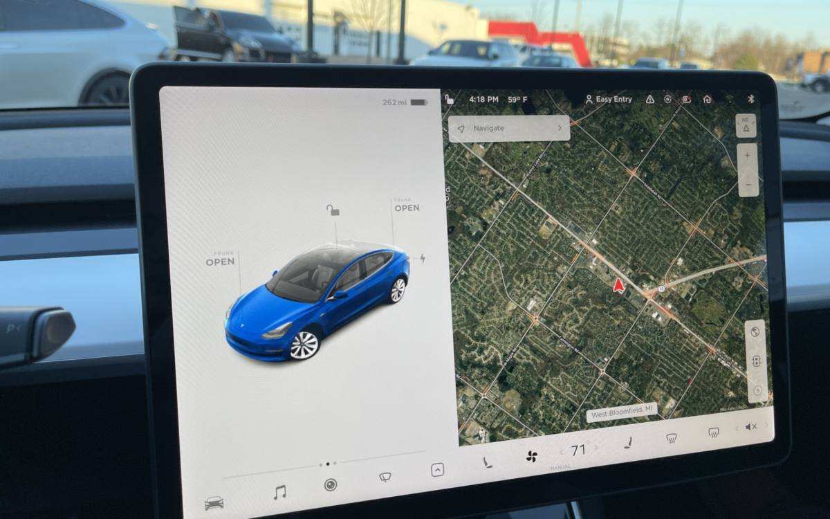 A Tesla Model 3 center screen, with the blue car on the left and the map on the right
