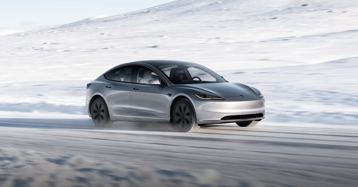 Silver Tesla Model 3 on a snow-covered road