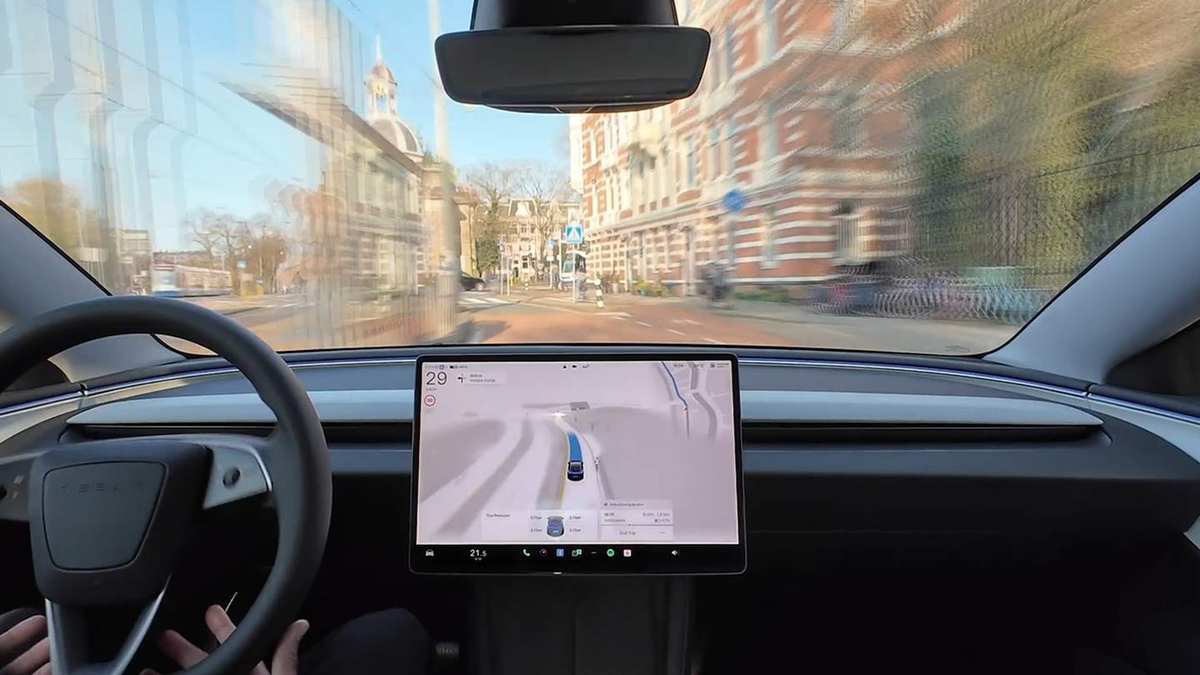 Tesla Model Y cabin with the steering wheel and the central screen showing the driving visualisation